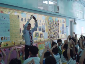 Teaching English in Hong Kong - singing at a school assembly.